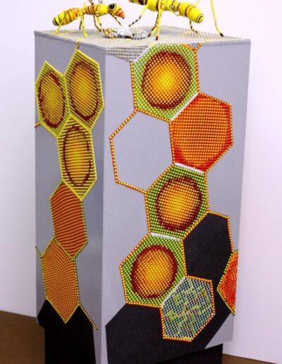 "The Wasp Tower" - 2012 - 50"h.x16.5"w.x18.5"d. Wrapped and cast paint applied to a wood pedestal. The wasps are acrylic paint strips wrapped over a wire